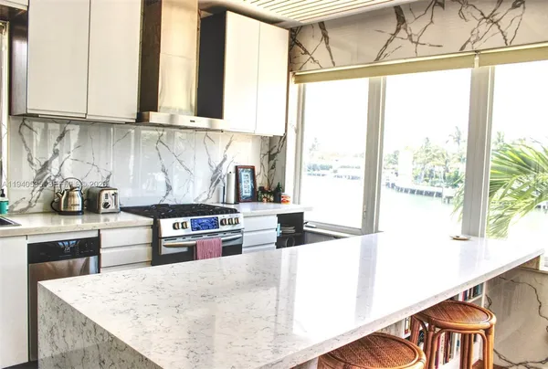 a kitchen with a stove a sink and a refrigerator
