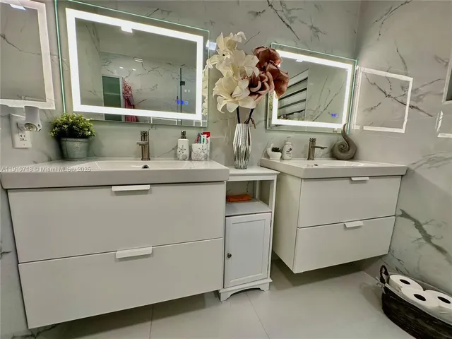 a utility room with cabinets and washer