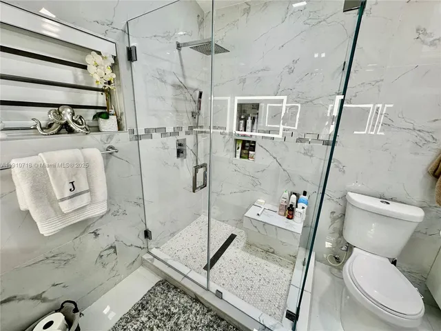 a bathroom with a toilet sink and shower