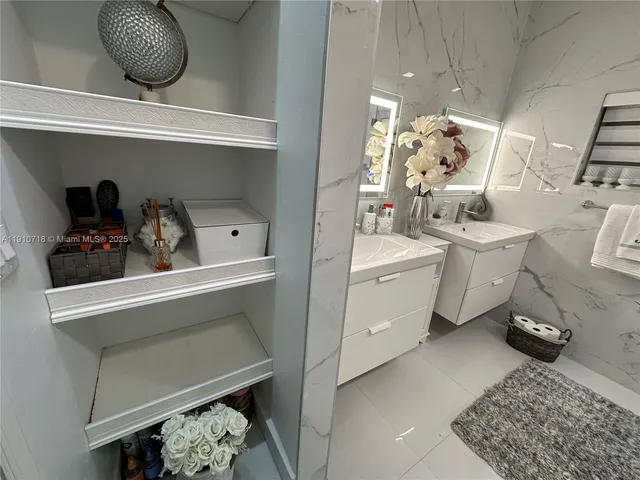 a bathroom with a sink mirror vanity and toilet