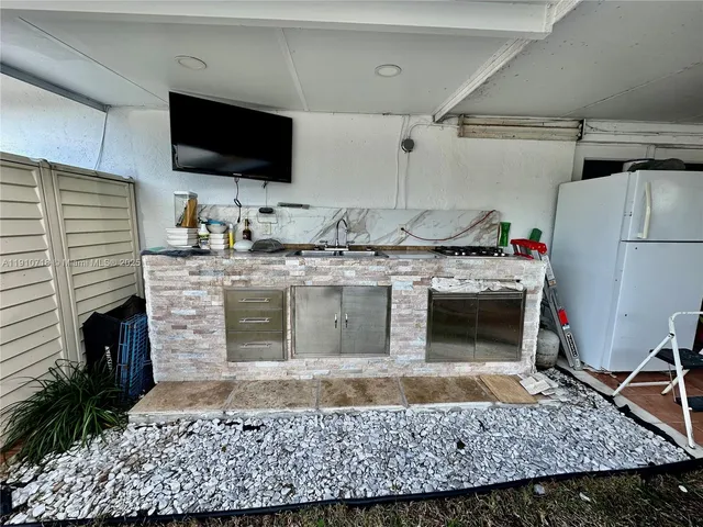 a living room with furniture and potted plants