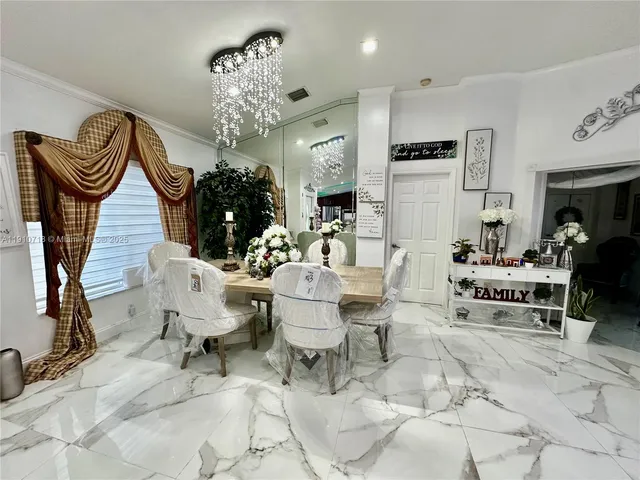 a living room with furniture chandelier and a chandelier