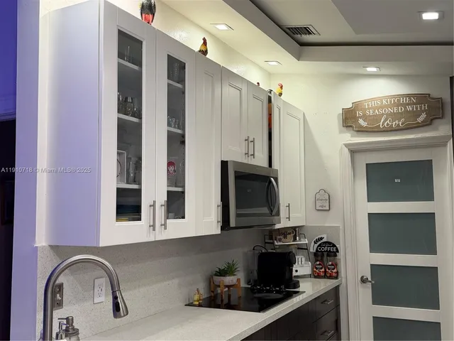 a kitchen with stainless steel appliances wooden cabinets and a refrigerator
