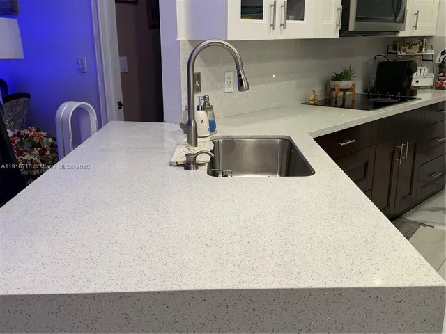 a kitchen with stainless steel appliances a refrigerator and a stove top oven