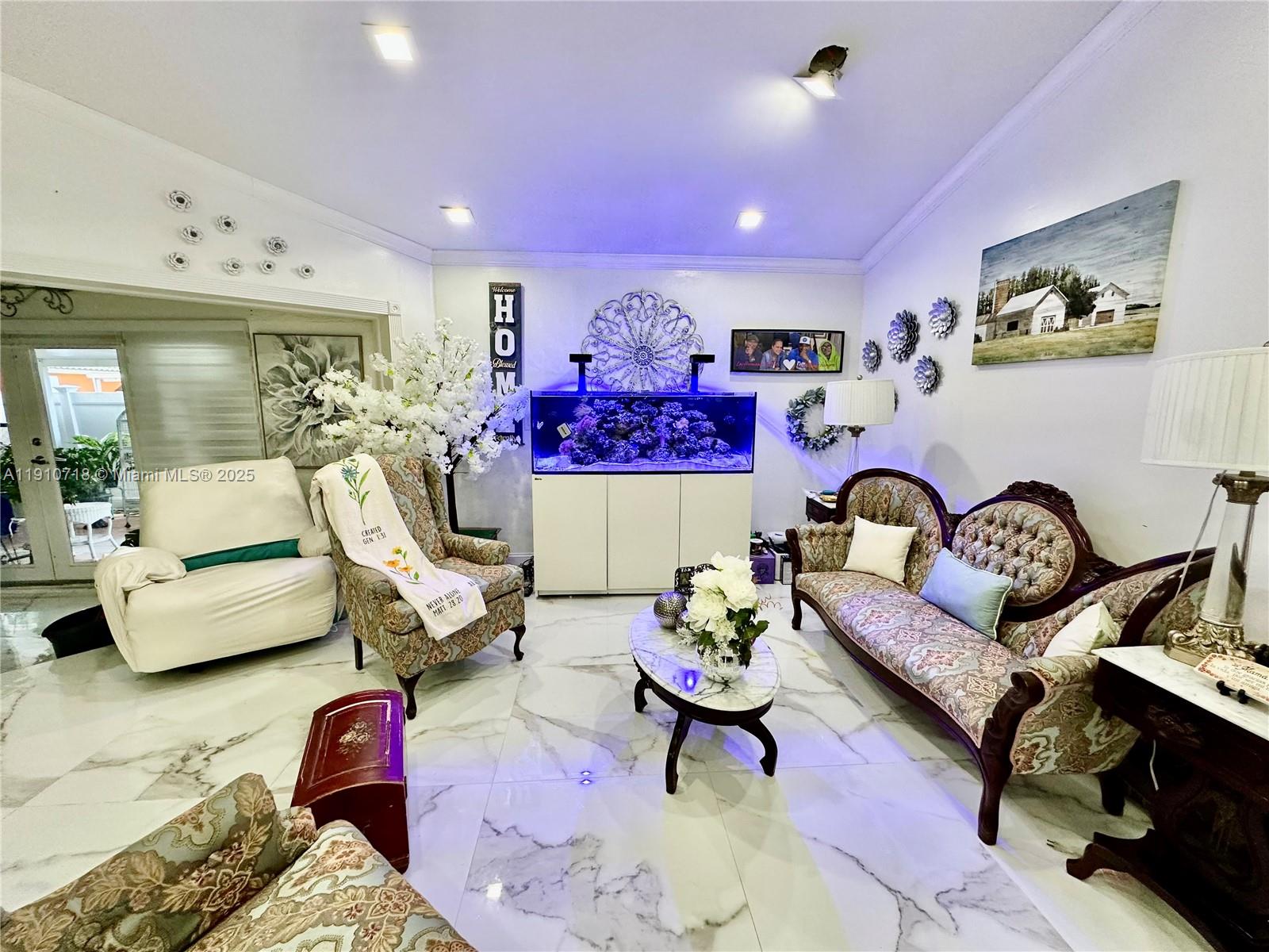 5259 Northwest 184th Lane Miami Gardens, FL 33055 - Photo 3 of 32 a living room with furniture and wall paintings