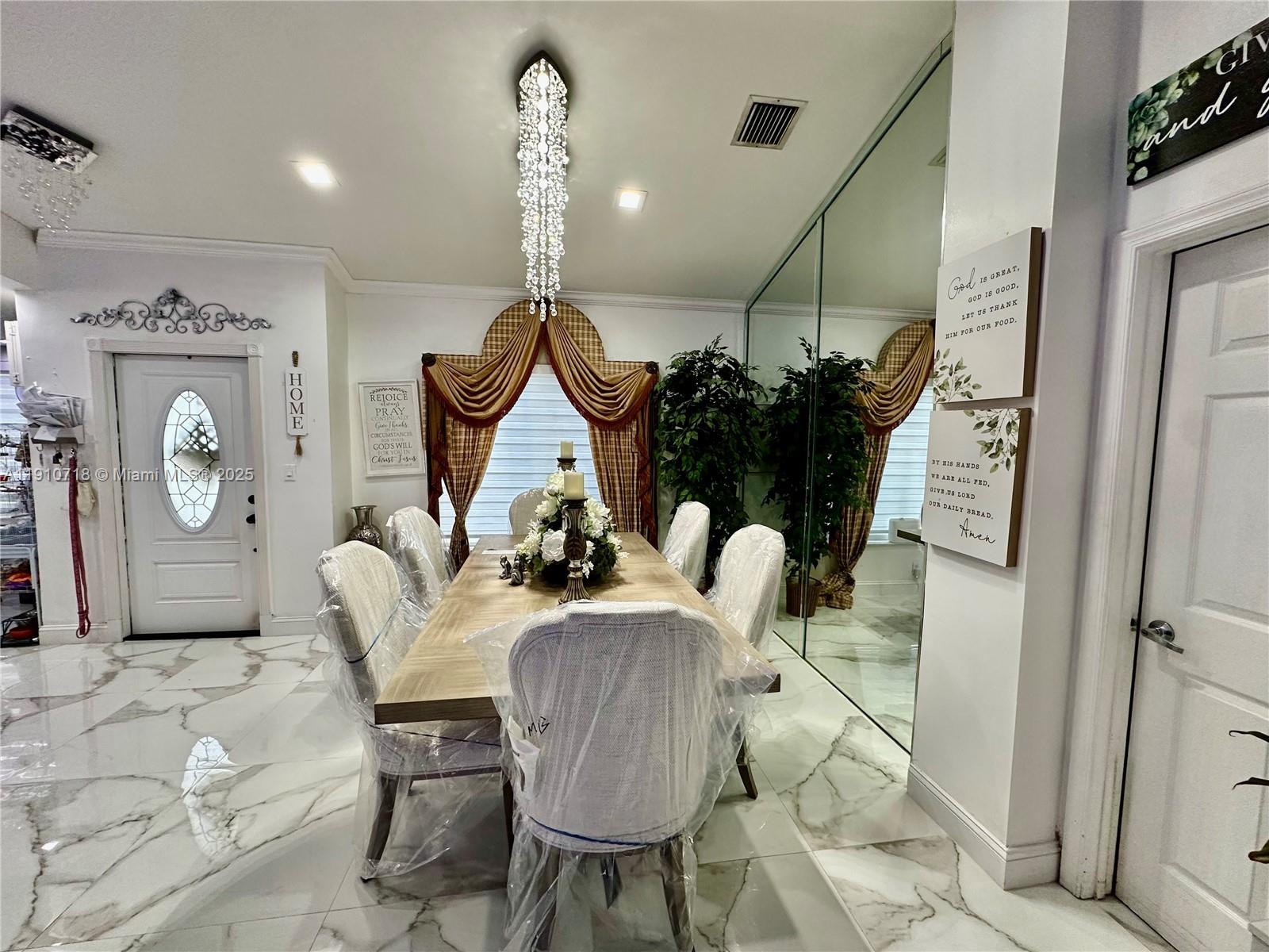 5259 Northwest 184th Lane Miami Gardens, FL 33055 - Photo 4 of 32 a living room with furniture a clock and a view of kitchen