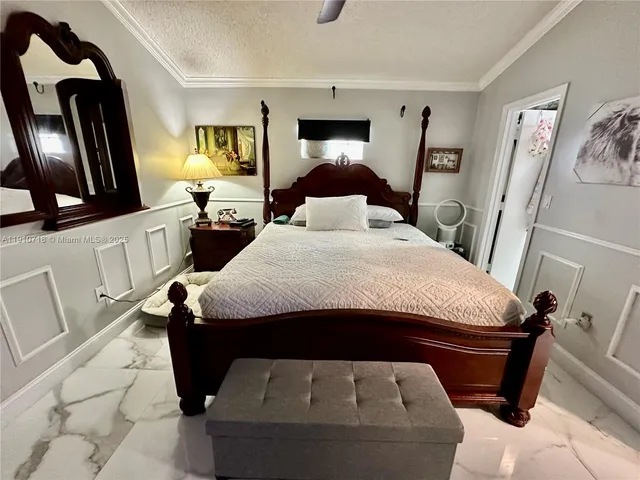 a bedroom with a bed and a mirror on dresser