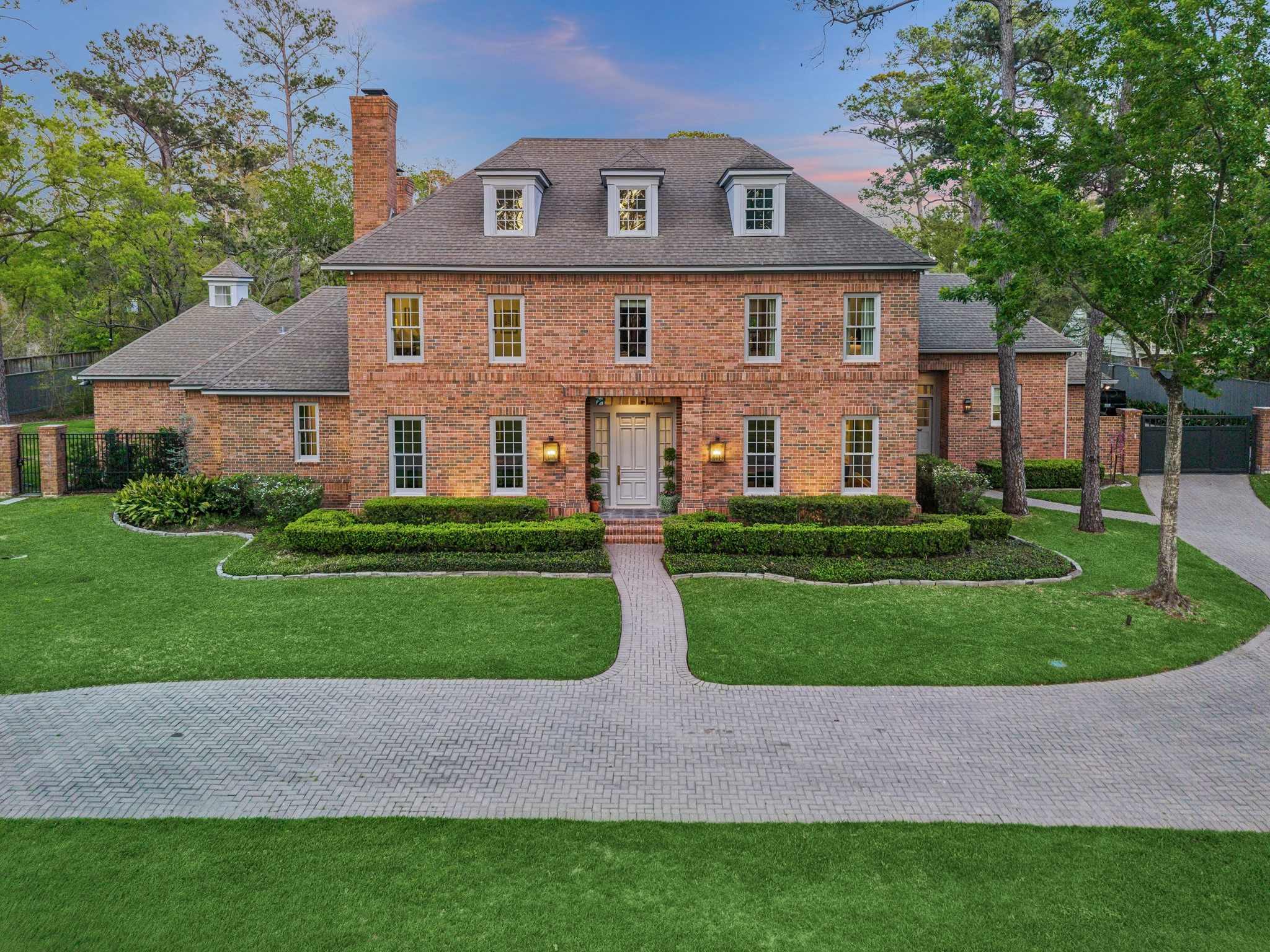 a front view of house with yard and green space