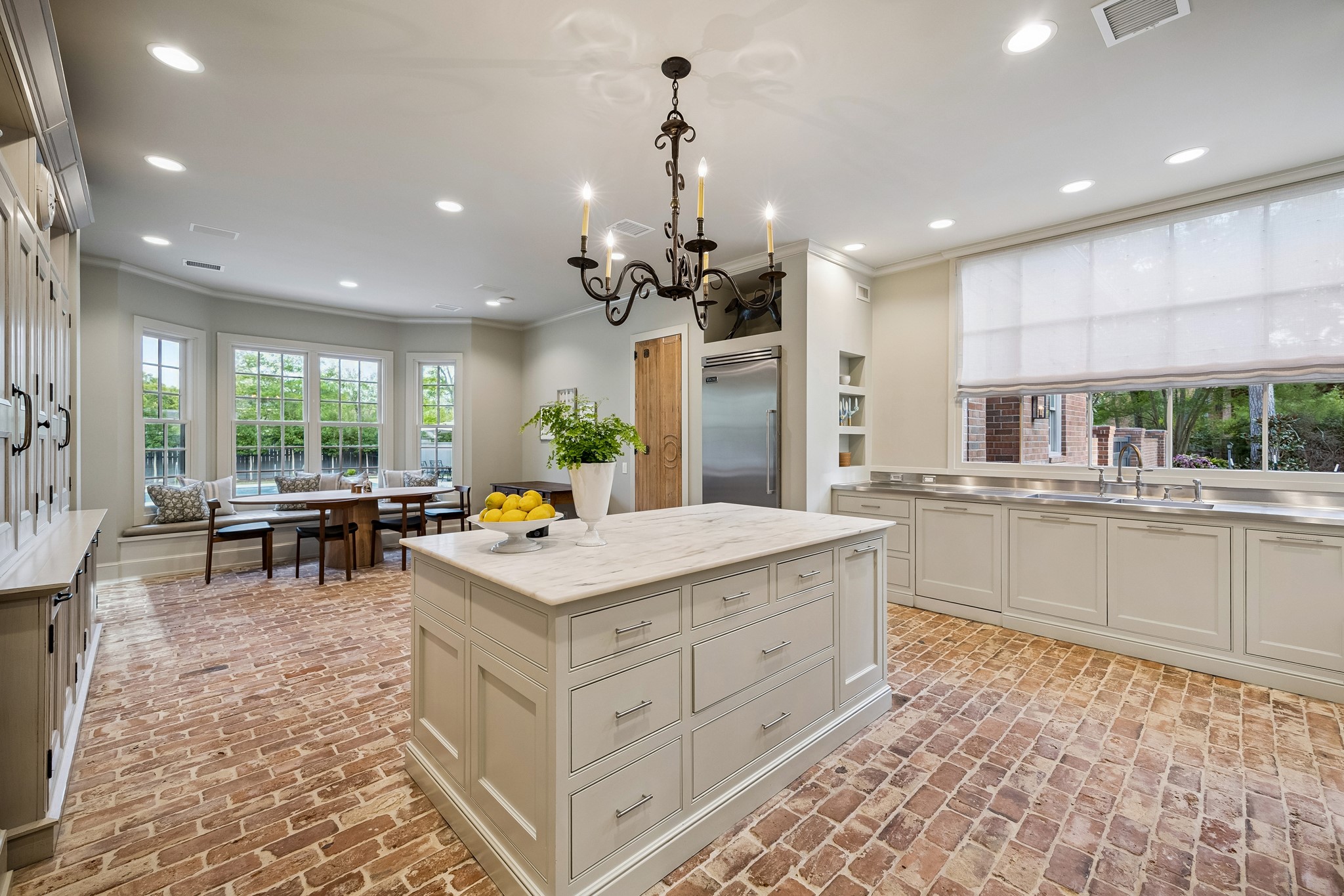448 Blalock Road Houston, TX 77024 - Photo 13 of 49 a kitchen that has a lot of cabinets a sink and wooden floor