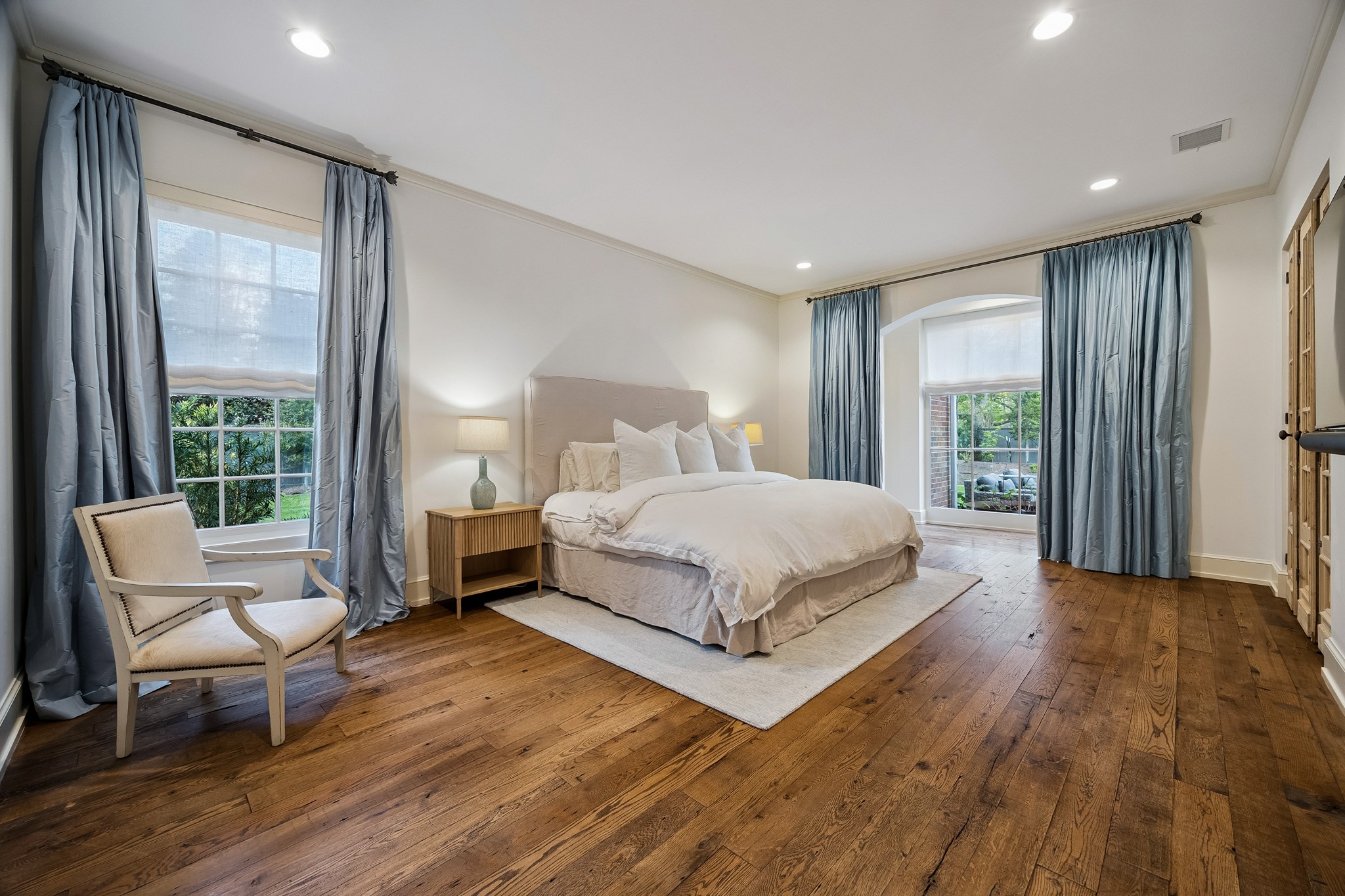 448 Blalock Road Houston, TX 77024 - Photo 22 of 49 a bedroom with a bed and large window