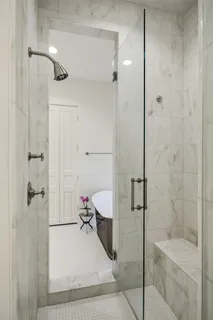 a bathroom with a tub sink and mirror