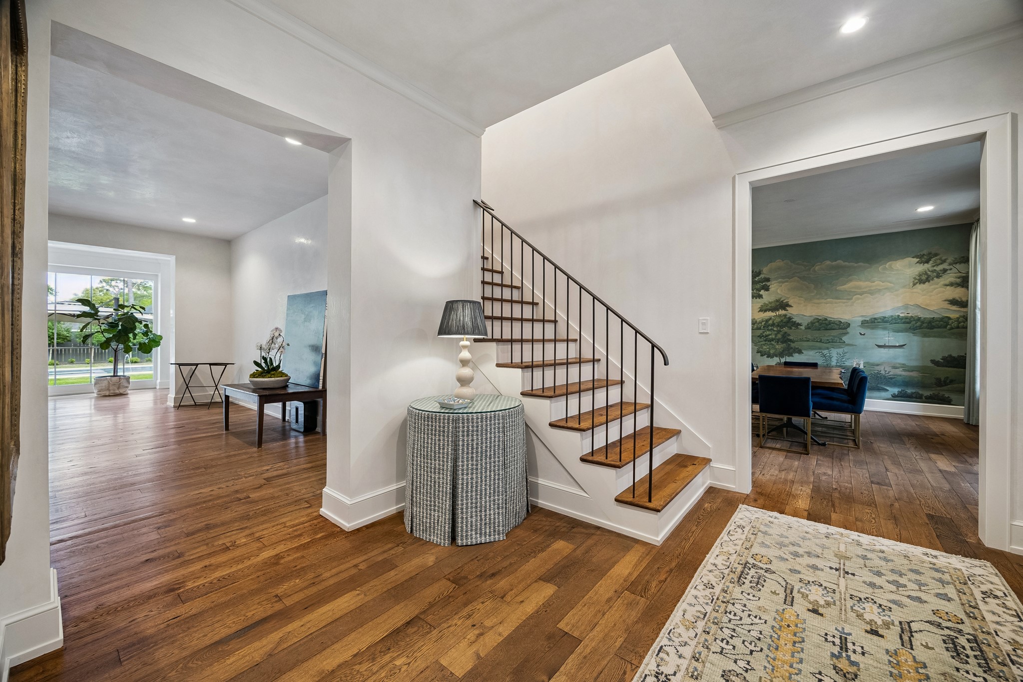 448 Blalock Road Houston, TX 77024 - Photo 3 of 49 a view of a hallway with dining room and wooden floor