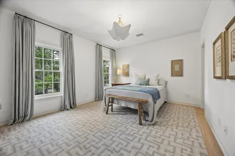a bathroom with a granite countertop sink a toilet and a mirror
