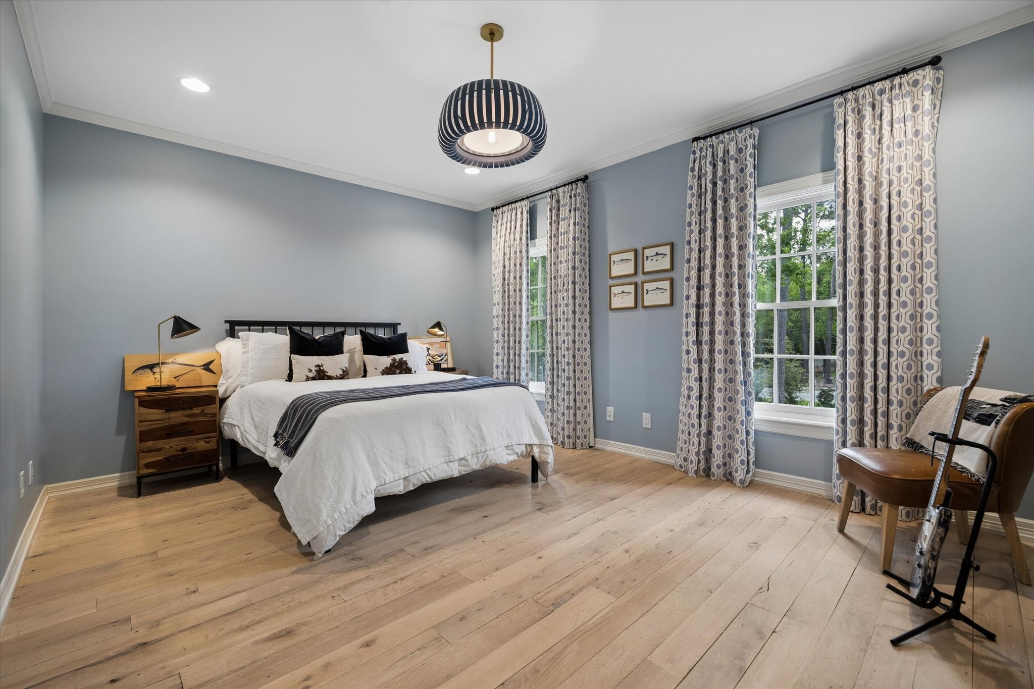 448 Blalock Road Houston, TX 77024 - Photo 37 of 49 a bedroom with a bed a chair and a large window