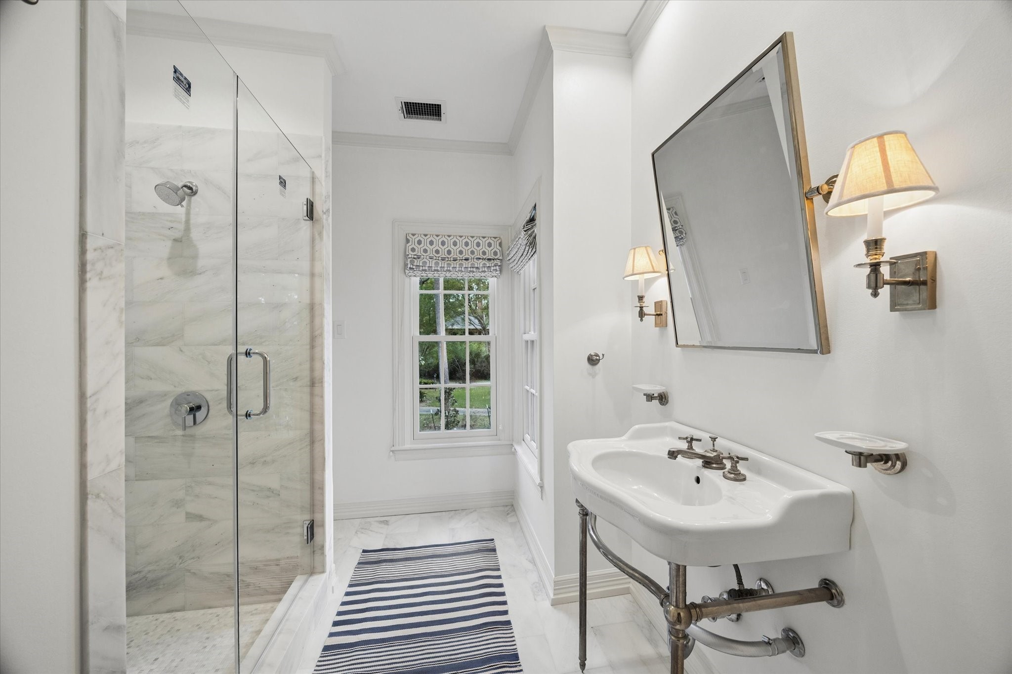 448 Blalock Road Houston, TX 77024 - Photo 38 of 49 a bathroom with a sink a mirror and shower