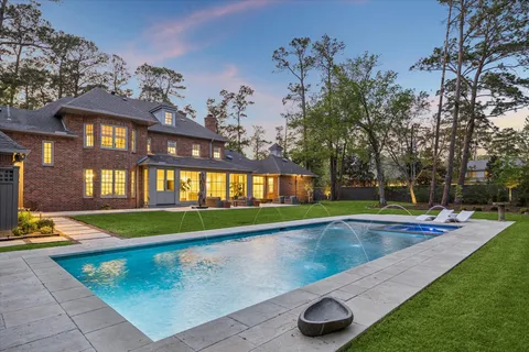 a swimming pool with outdoor seating and yard