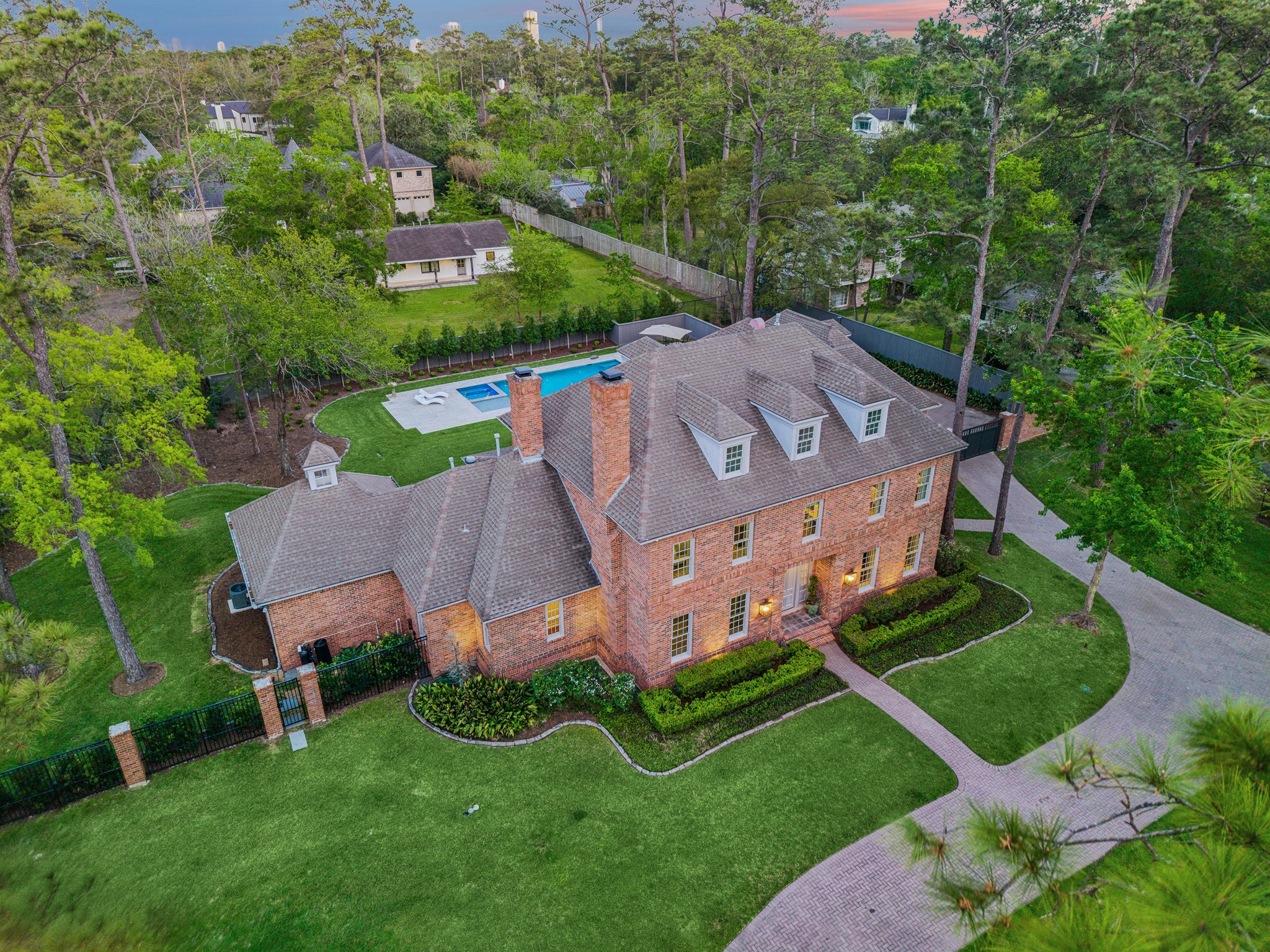448 Blalock Road Houston, TX 77024 - Photo 46 of 49 An elevated perspective showcases the backyard’s resort-style pool, curb appeal, and situates the home within its expansive, beautifully landscaped grounds, highlighting privacy, scale, and seamless outdoor living.