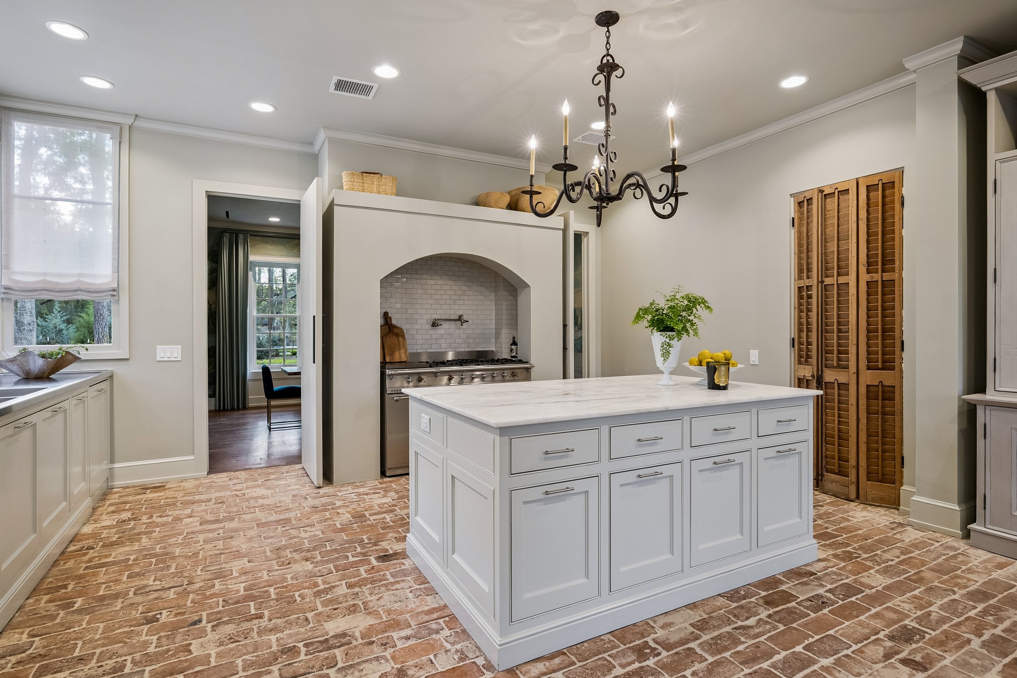 448 Blalock Road Houston, TX 77024 - Photo 6 of 49 a kitchen that has a lot of cabinets in it and wooden flooring