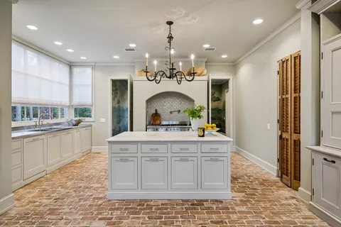 a view of living room with kitchen island stainless steel appliances furniture a rug and a view