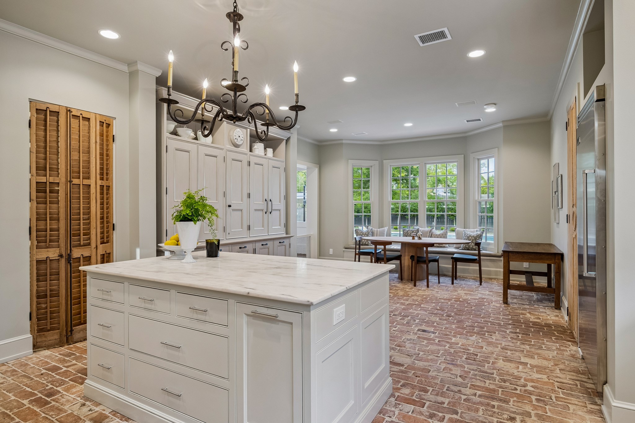 448 Blalock Road Houston, TX 77024 - Photo 9 of 49 a dining hall with stainless steel appliances kitchen island granite countertop furniture and a chandelier