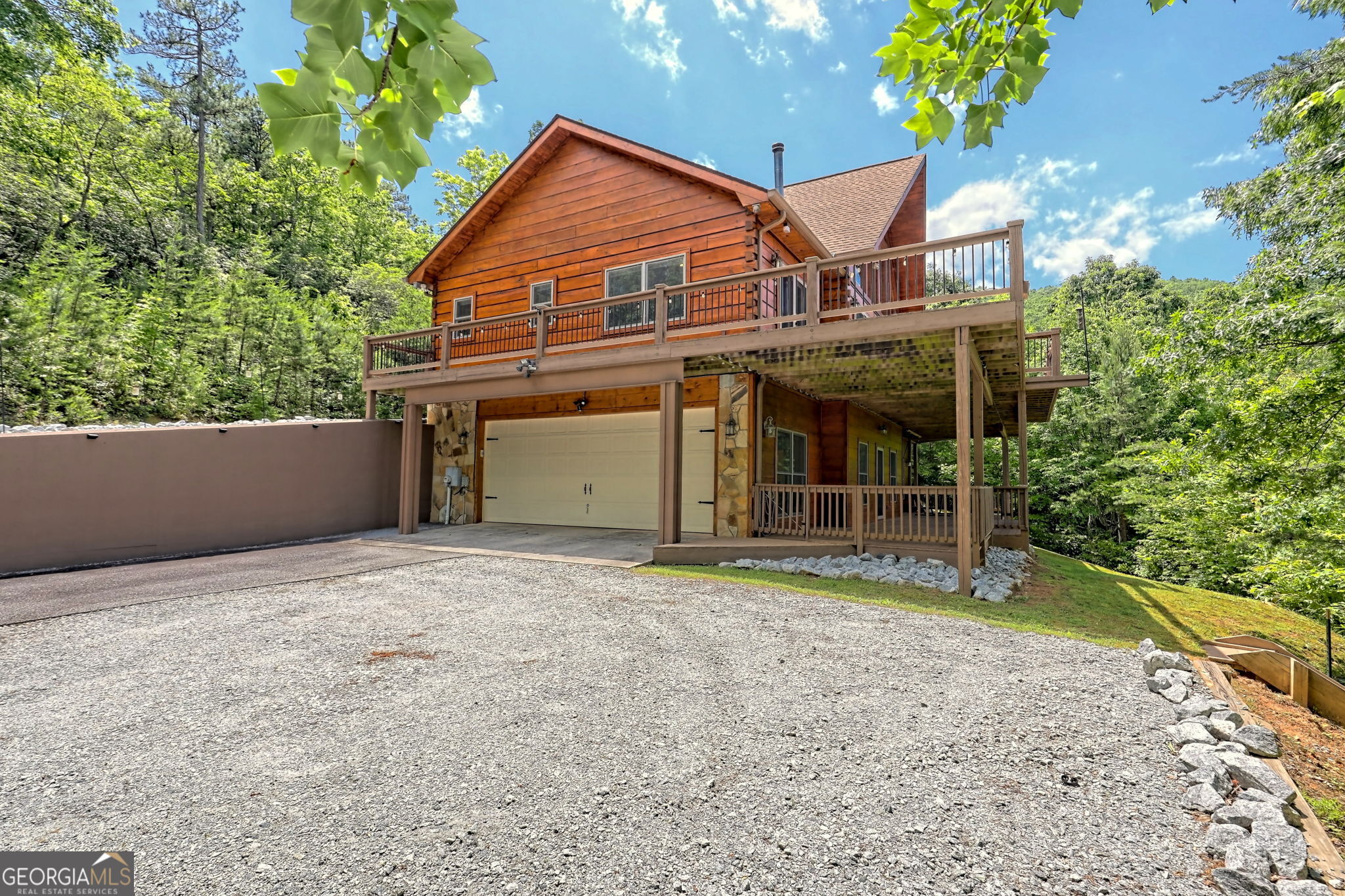 a view of a house with a yard and potted plants