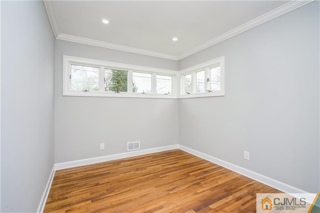36 Princeton Road Old Bridge, NJ 08859 - Photo 13 of 19 a view of empty room with wooden floor and fan