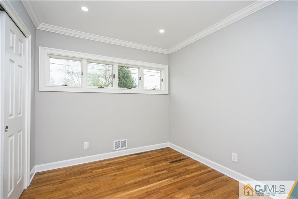 36 Princeton Road Old Bridge, NJ 08859 - Photo 14 of 19 a view of an empty room with wooden floor and a window