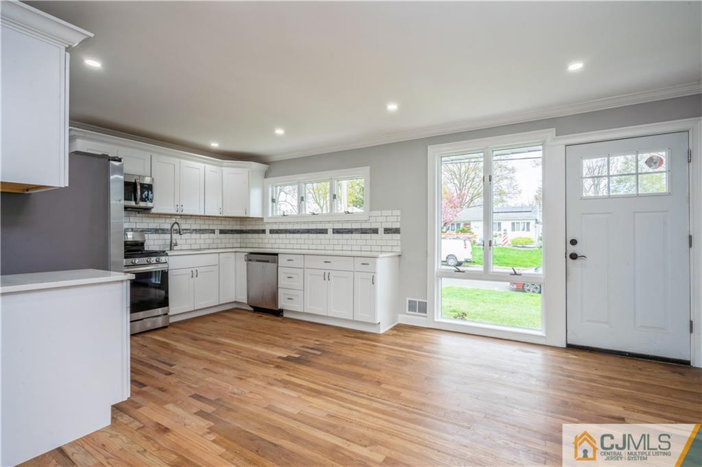 36 Princeton Road Old Bridge, NJ 08859 - Photo 3 of 19 a kitchen with a stove a sink and a refrigerator