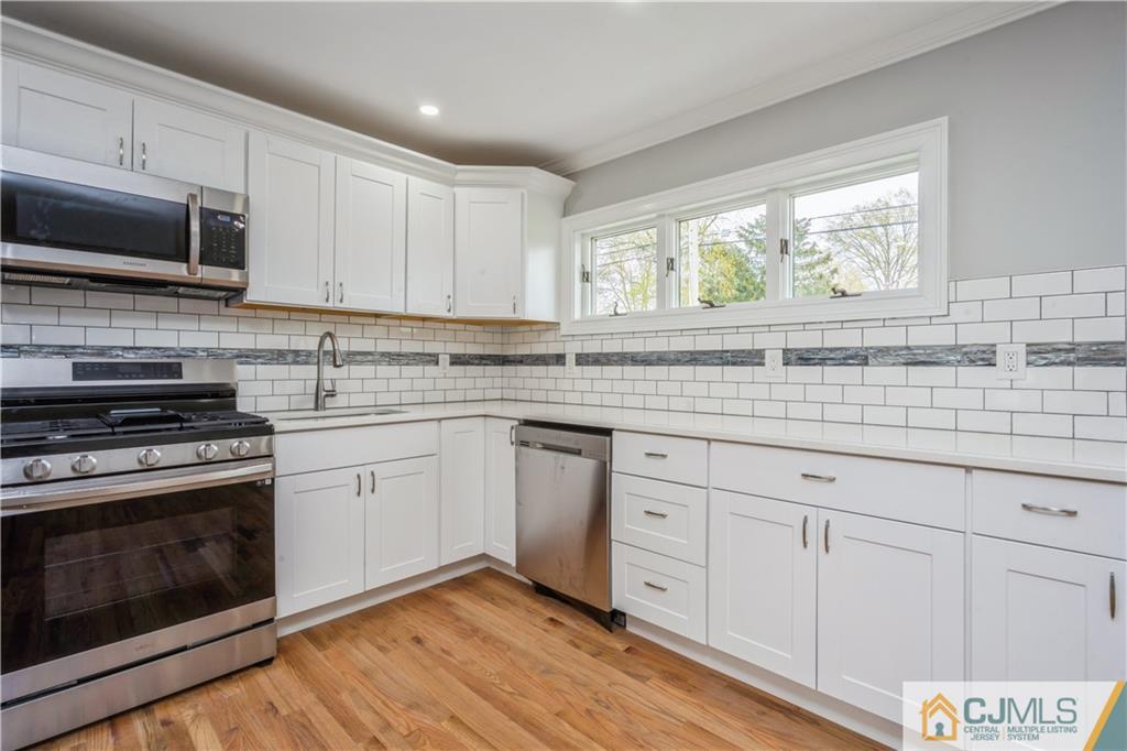 36 Princeton Road Old Bridge, NJ 08859 - Photo 4 of 19 a kitchen with granite countertop white cabinets stainless steel appliances and sink