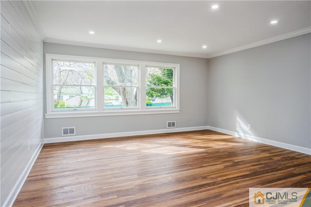 36 Princeton Road Old Bridge, NJ 08859 - Photo 8 of 19 a view of an empty room with wooden floor and a window