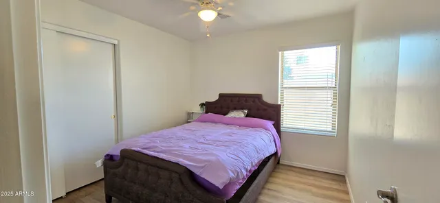 a bedroom with a bed and a window