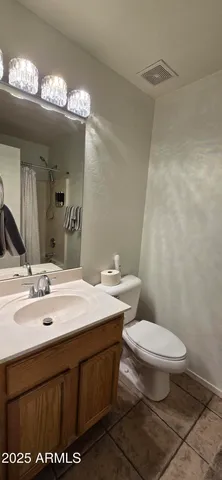 a bathroom with a sink a toilet a mirror and vanity