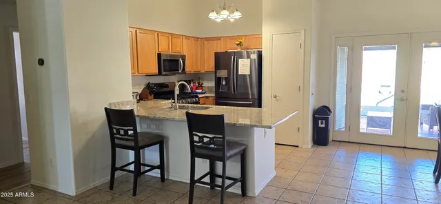 a kitchen with stainless steel appliances a stove a refrigerator and a microwave