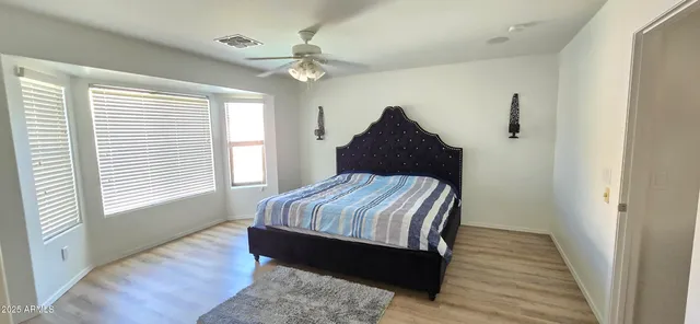 a bedroom with bed and window