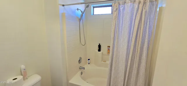 a bathroom with a shower and a sink