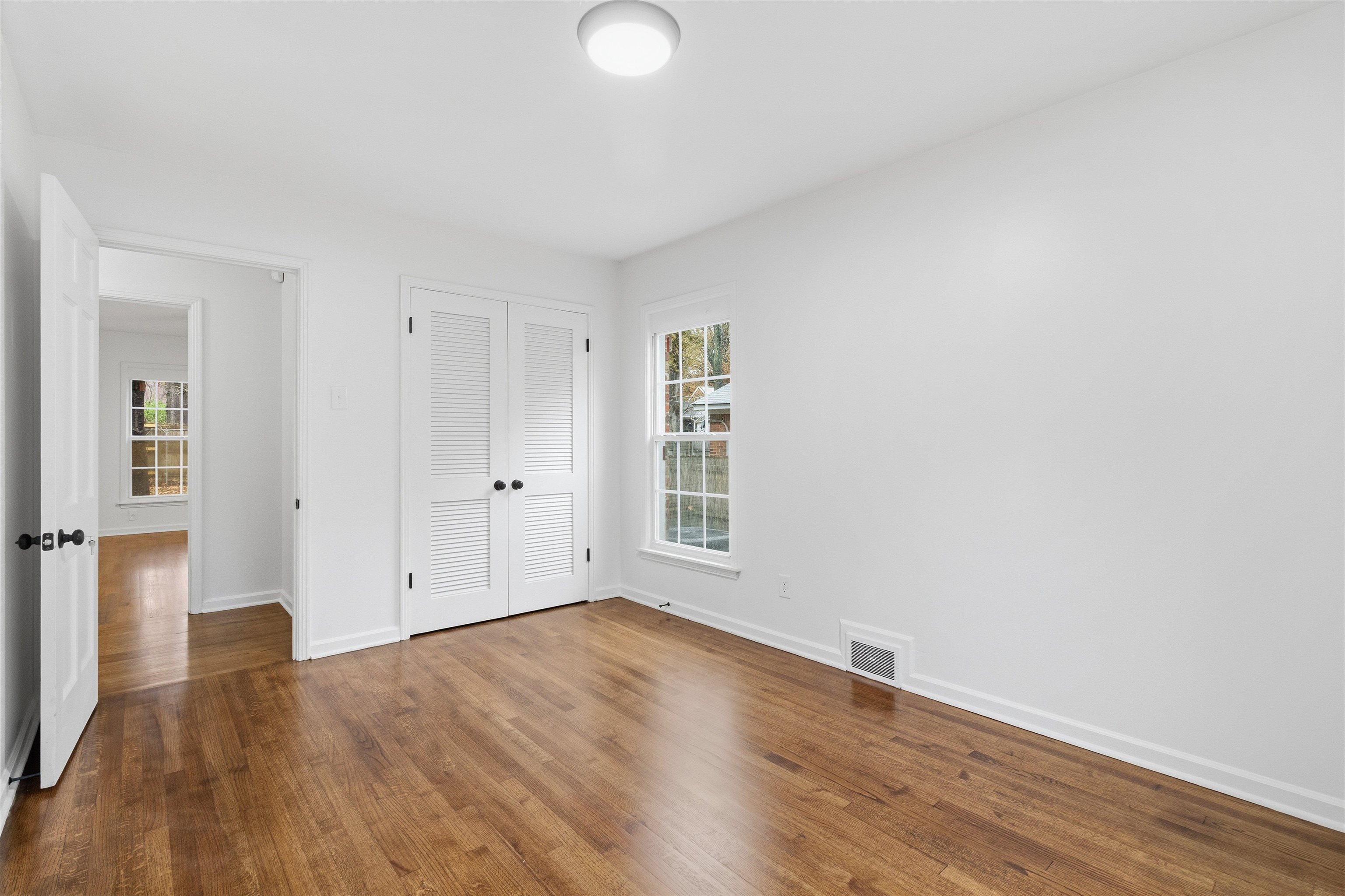 416 Rosser Road Memphis, TN 38120 - Photo 21 of 30 an empty room with wooden floor and windows