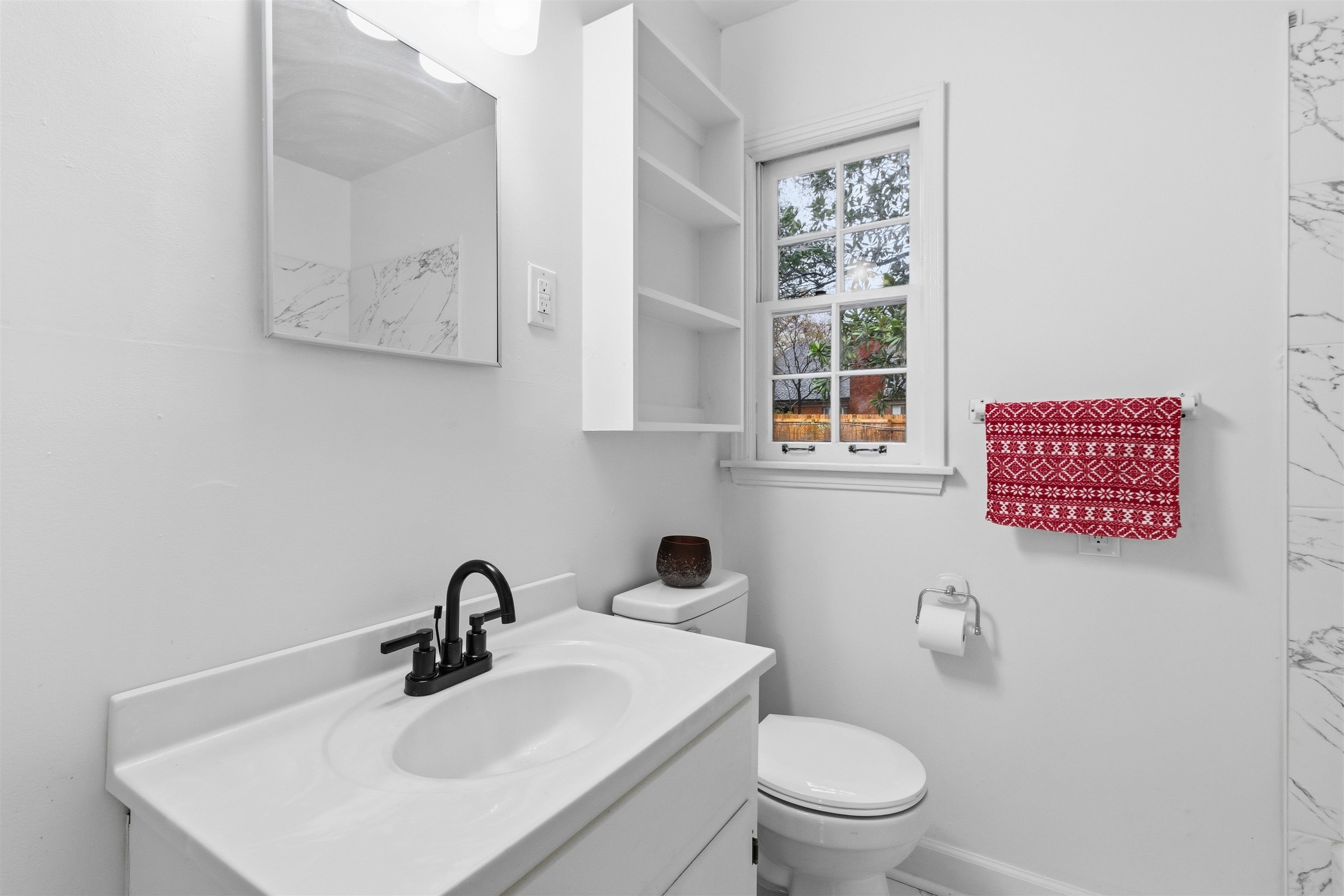 416 Rosser Road Memphis, TN 38120 - Photo 23 of 30 a bathroom with a toilet a sink and mirror