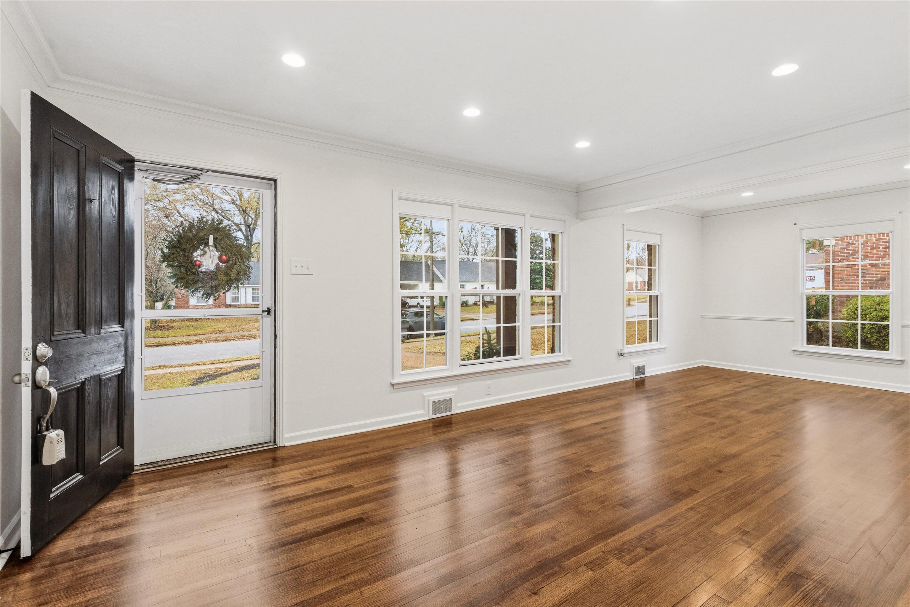 416 Rosser Road Memphis, TN 38120 - Photo 5 of 30 a view of an empty room with a window and wooden floor