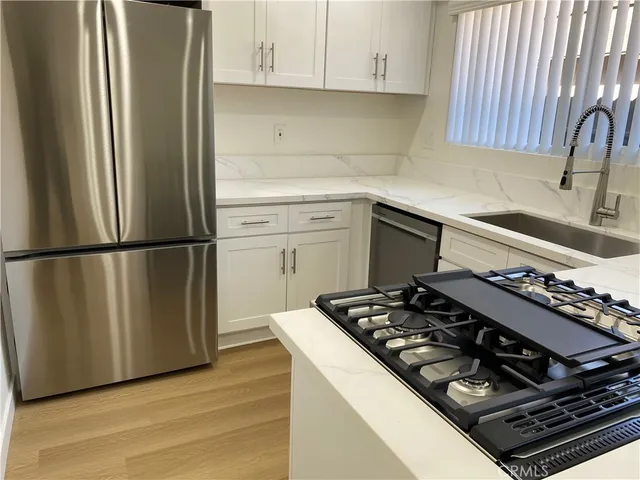 a kitchen with wooden cabinets and a stove top oven