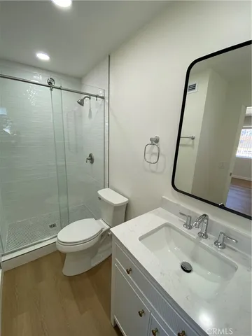 a bathroom with a double vanity sink toilet and shower