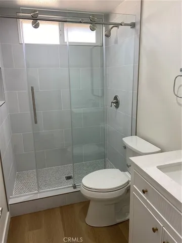 a bathroom with a toilet and a shower