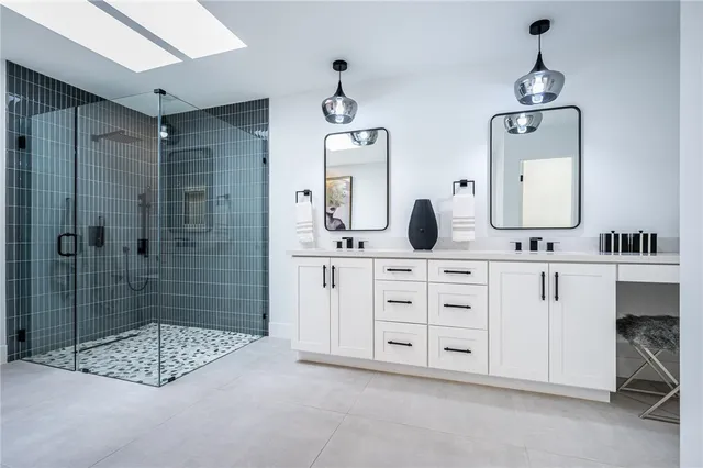 a bathroom with double sink and a mirror