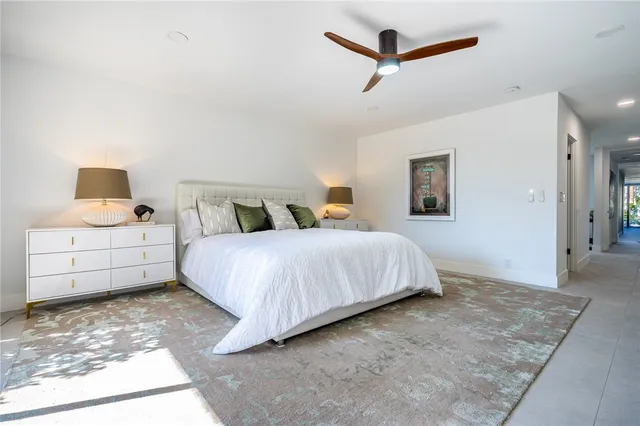 a bedroom with a bed and a night stand