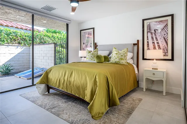 a spacious bedroom with a bed and large window