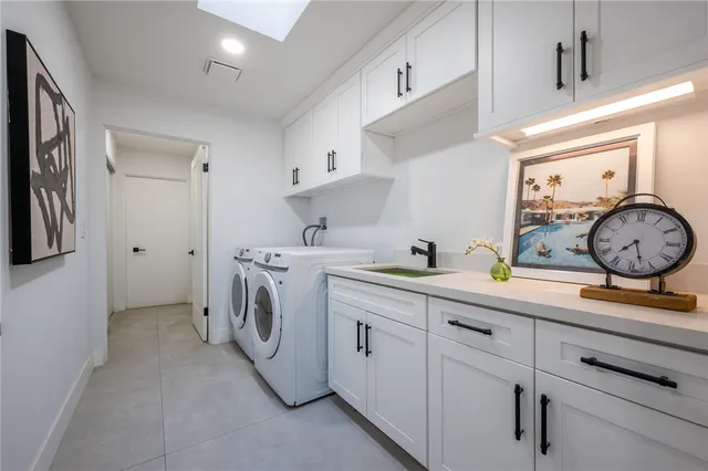 a view of kitchen with sink washer and dryer