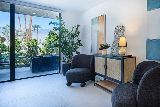 a living room with furniture and a potted plant