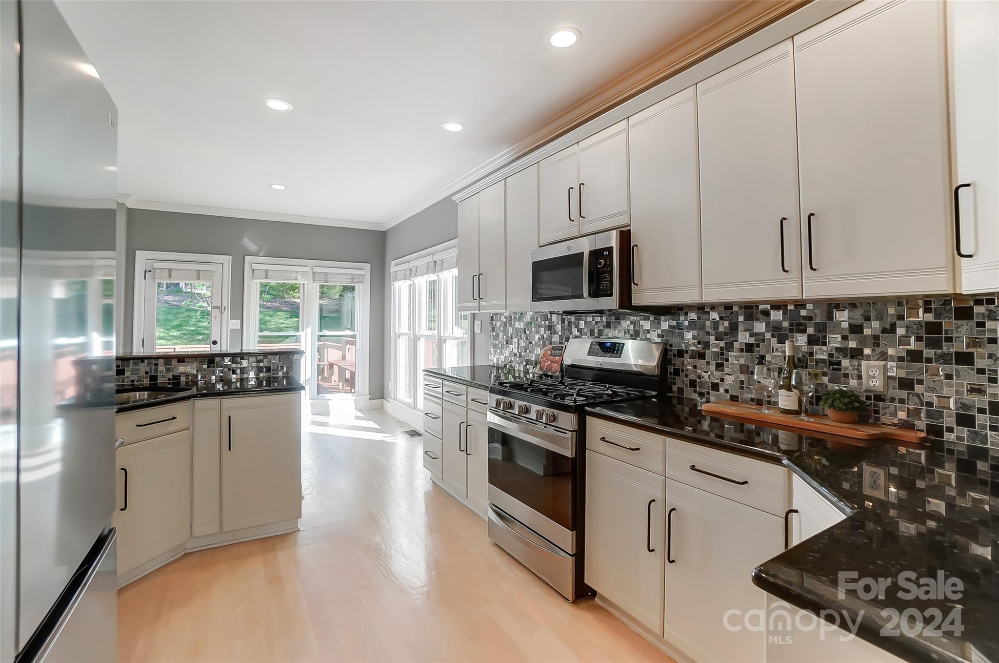 657 Portpatrick Place Fort Mill, SC 29708 - Photo 11 of 46 a kitchen with stainless steel appliances granite countertop a stove a sink and a microwave