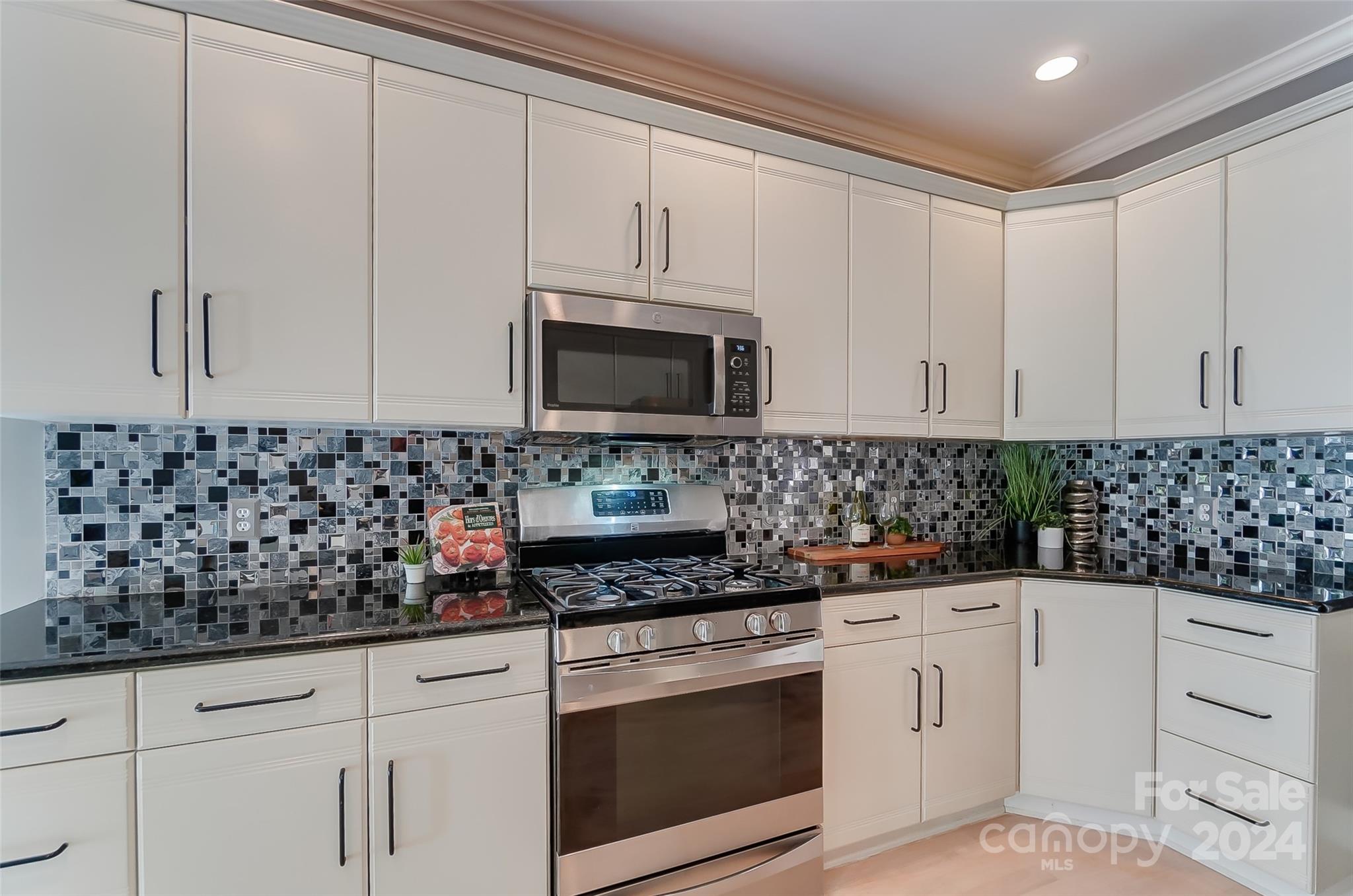 657 Portpatrick Place Fort Mill, SC 29708 - Photo 12 of 46 a kitchen with white cabinets and white appliances