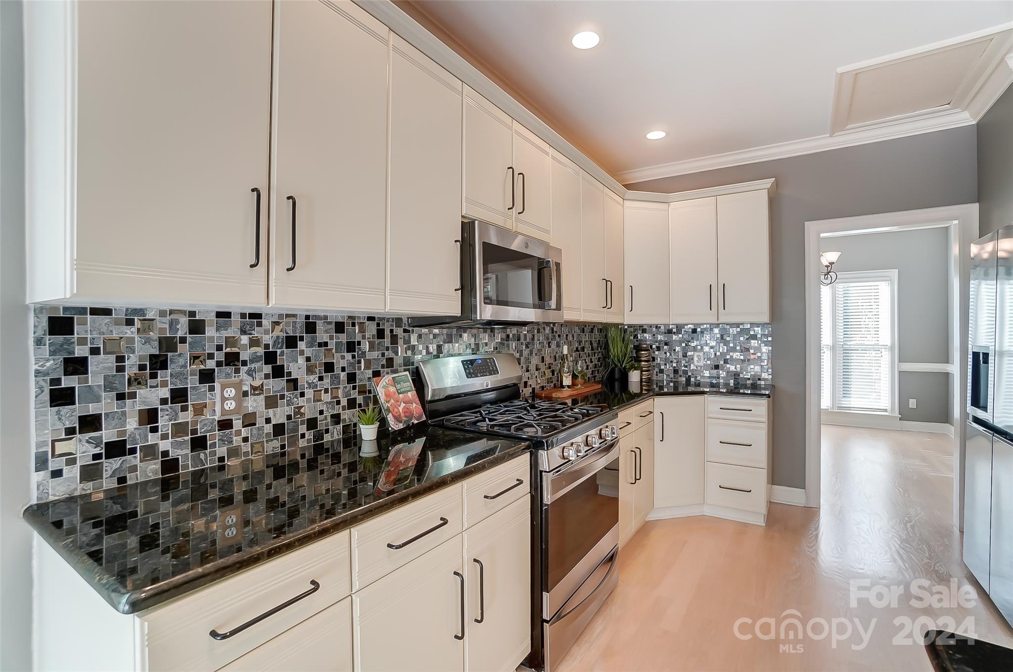 657 Portpatrick Place Fort Mill, SC 29708 - Photo 13 of 46 a kitchen with granite countertop a sink and a stove top oven