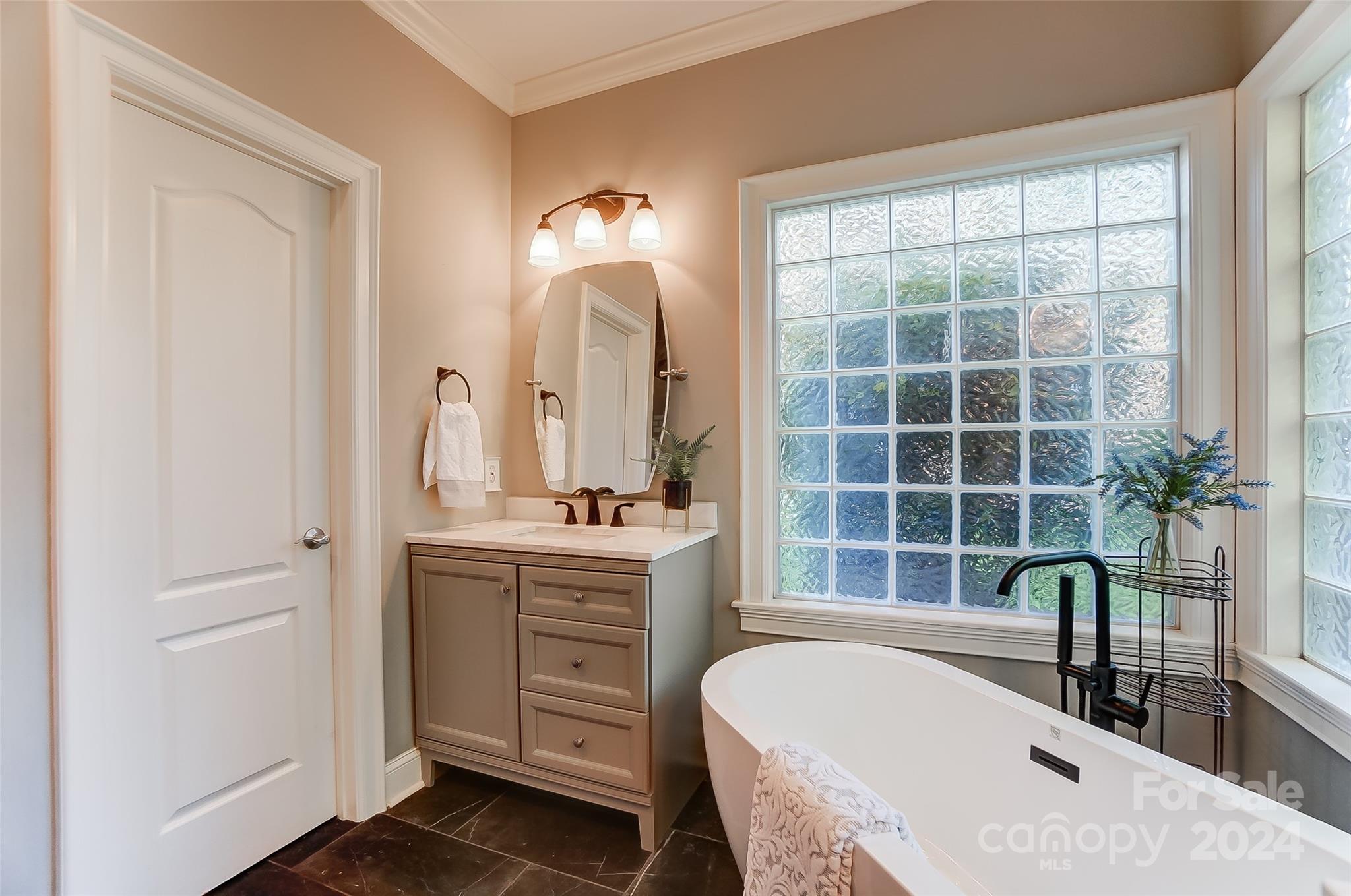 657 Portpatrick Place Fort Mill, SC 29708 - Photo 22 of 46 a spacious bathroom with a granite countertop tub sink a mirror and a window